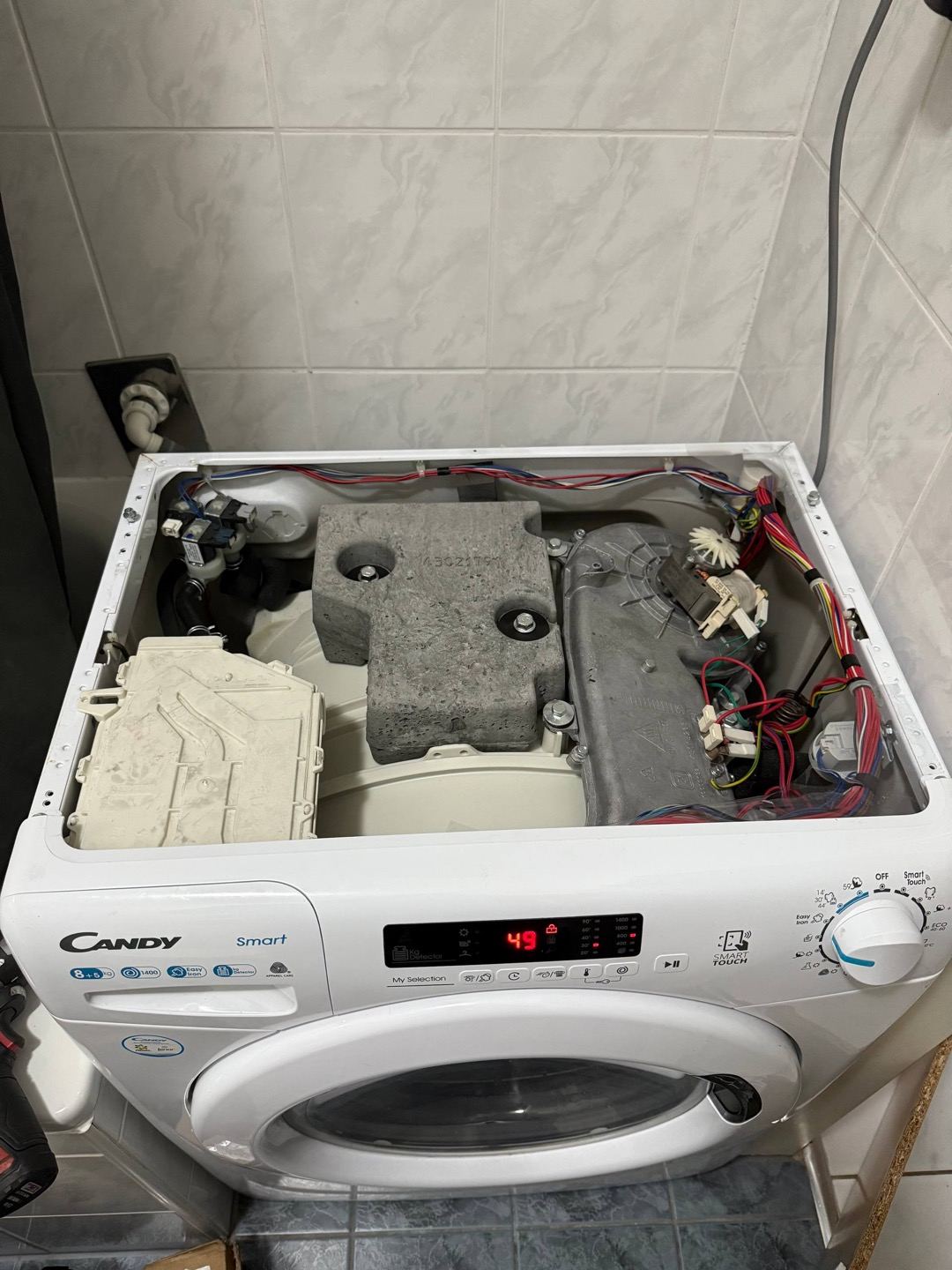 technician repairing a washing machine