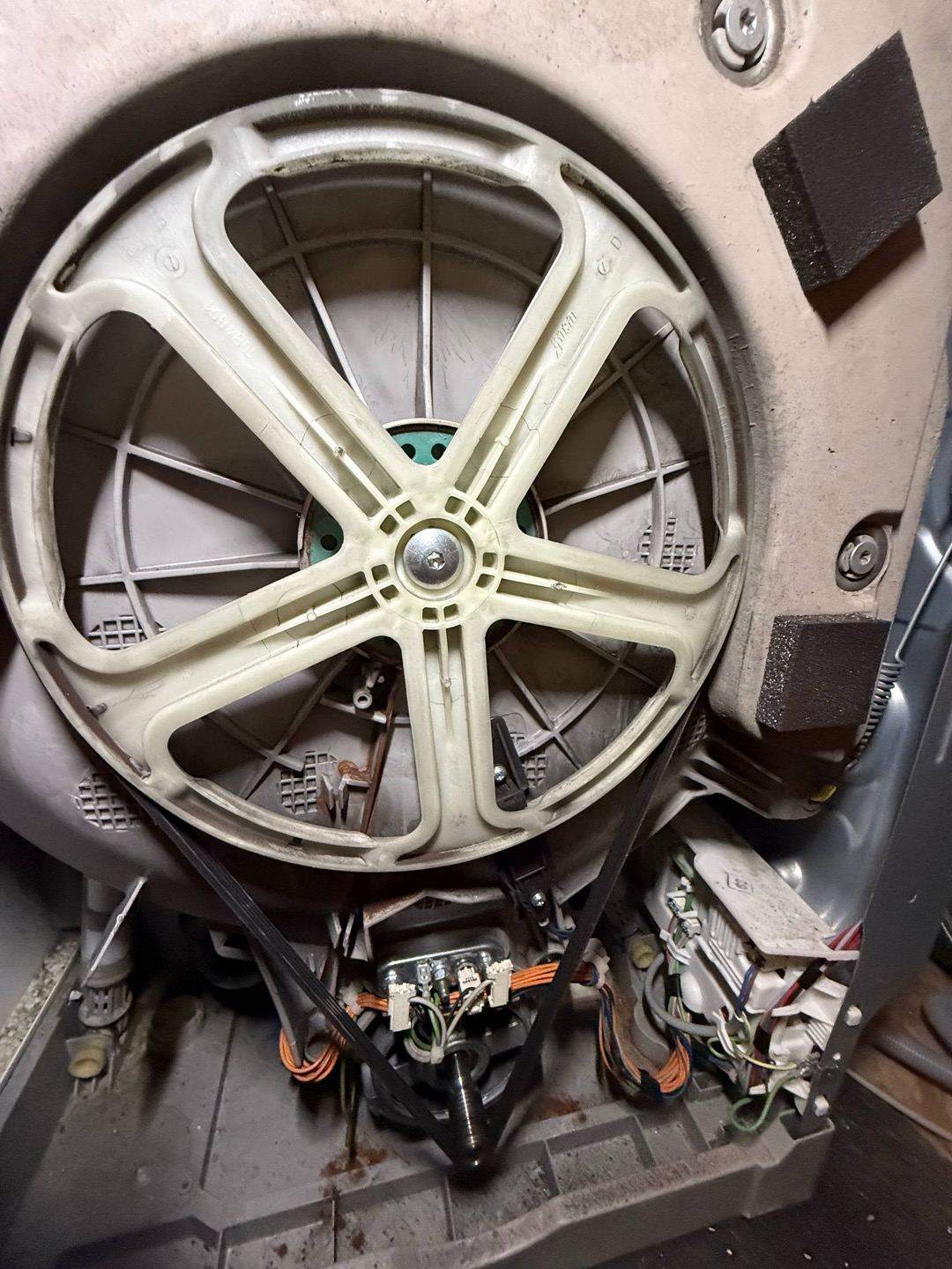 technician repairing a washing machine