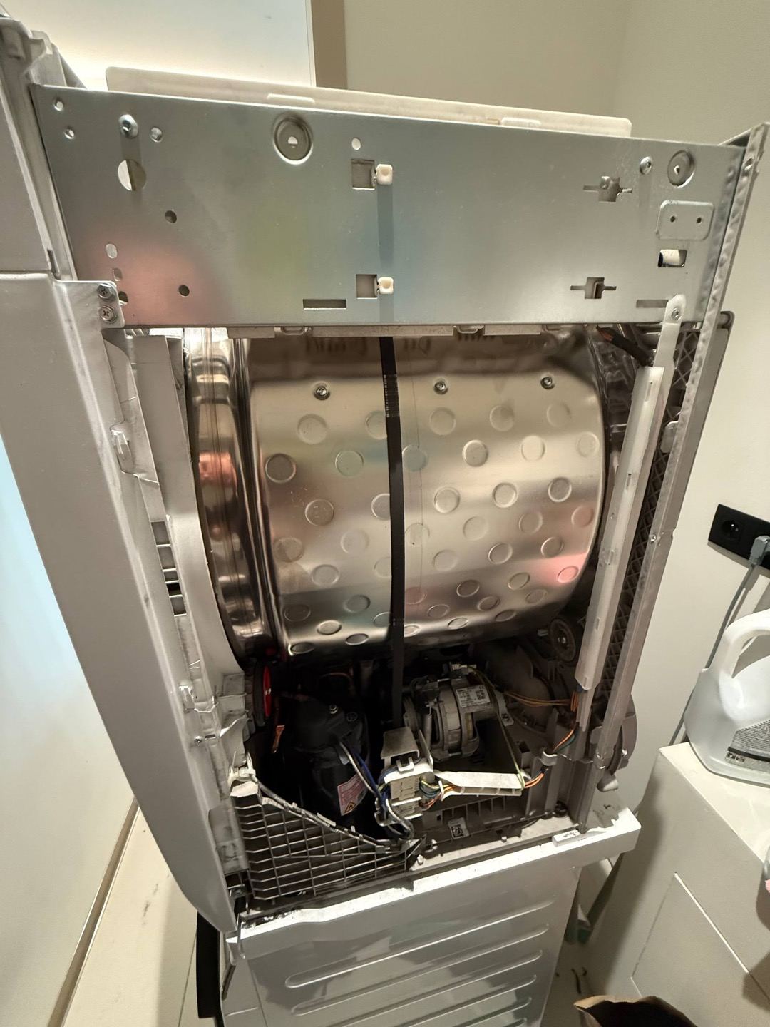 technician repairing a washing machine